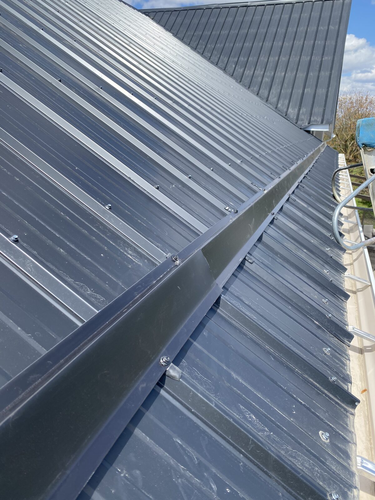 Eavestrough installation crew on a residential roof in Guelph